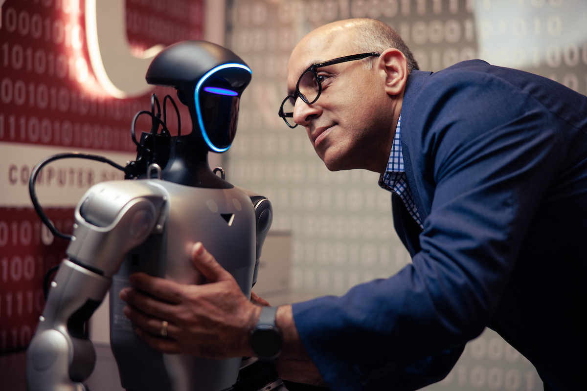 Dr. Rahimi examines a robot.